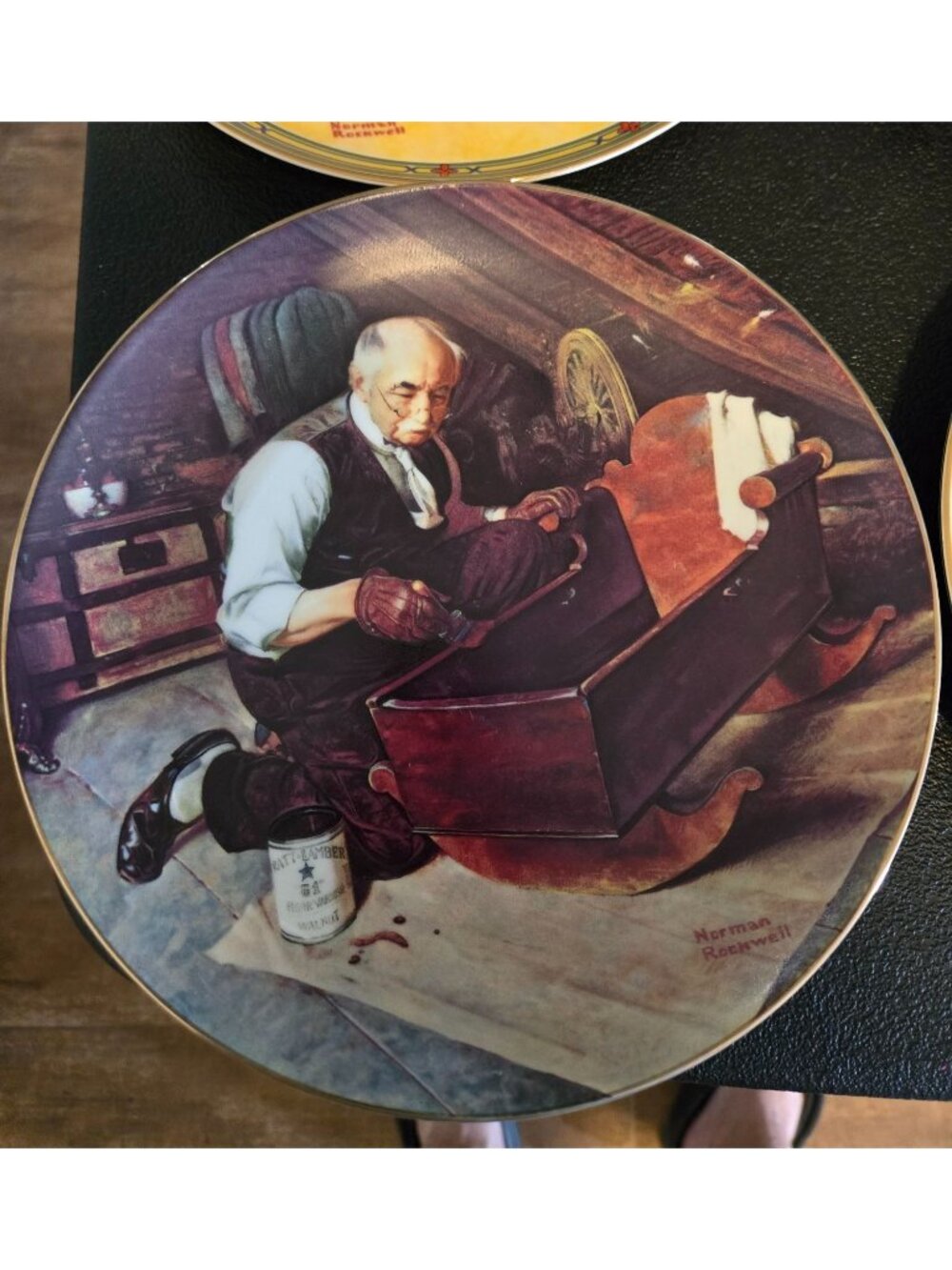 A collector numbered plate titled "Grandpa's Gift" by Norman Rockwell.